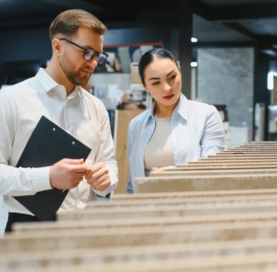 a person looking at flooring material