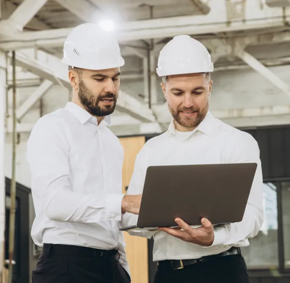 2 man designing a commercial flooring plan on laptop.